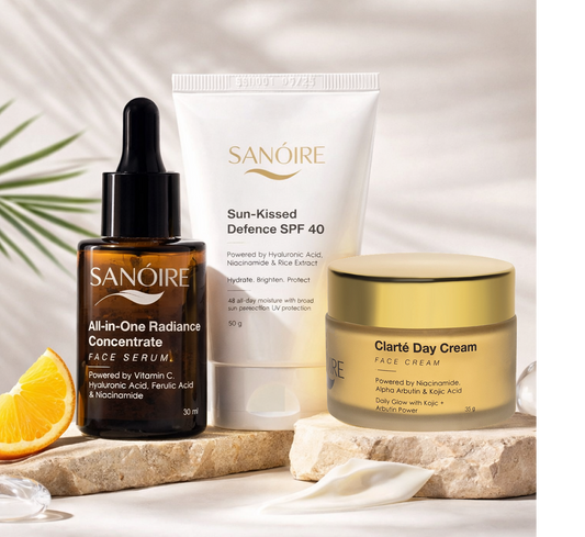Three skincare products with vitamin C, niacinamide, hyaluronic acid, and SPF 40 on a stone surface.