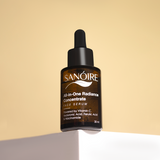 Amber dropper bottle of all-in-one radiance face serum with Vitamin C and niacinamide