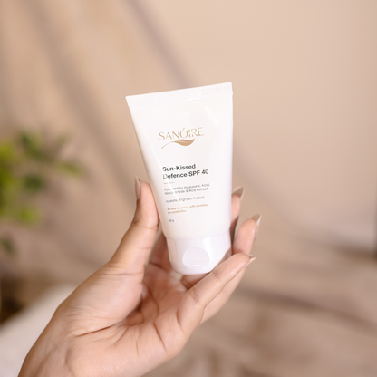 Hand holding Sun-Kissed Defence SPF 40 sunscreen tube for skin barrier protection